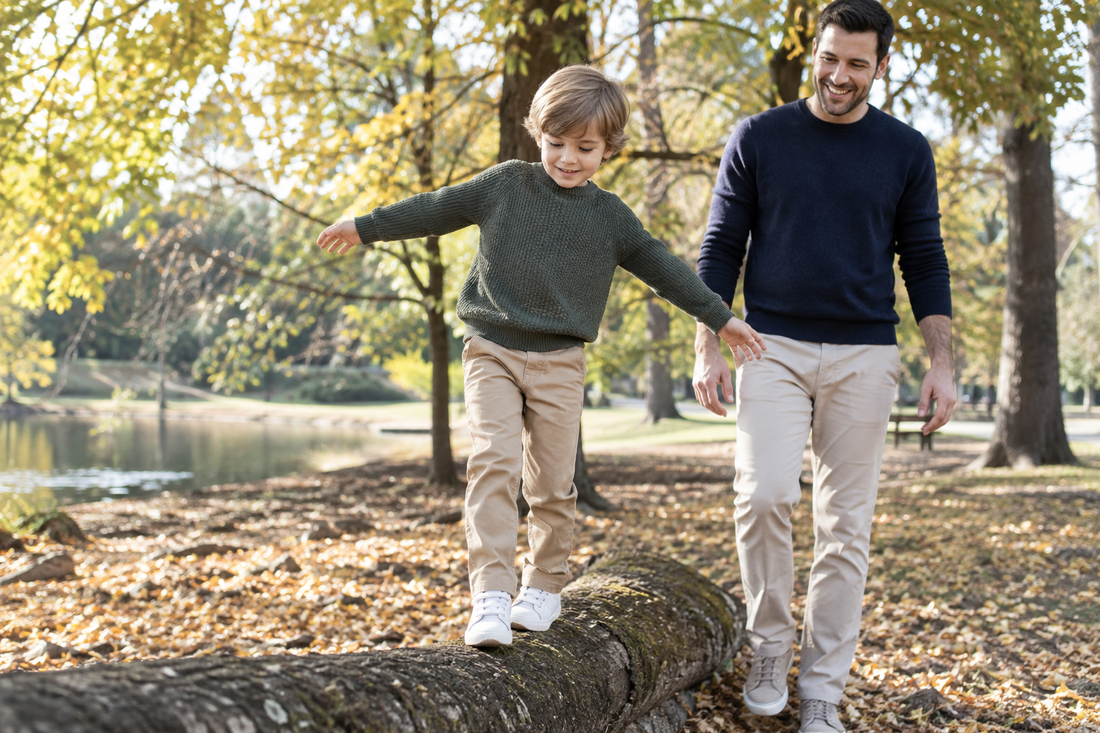 Boy wearing comfortable casual pants while walking with his father in a park
