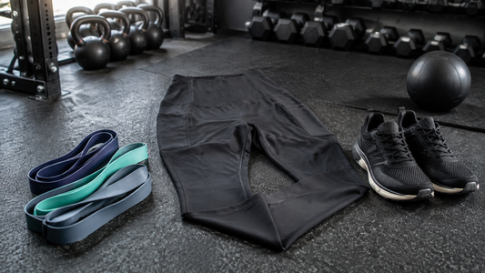 Performance workout leggings arranged with gym accessories