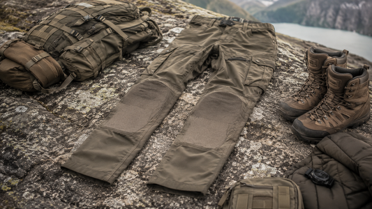 Tactical pants arranged beside hiking boots and field gear