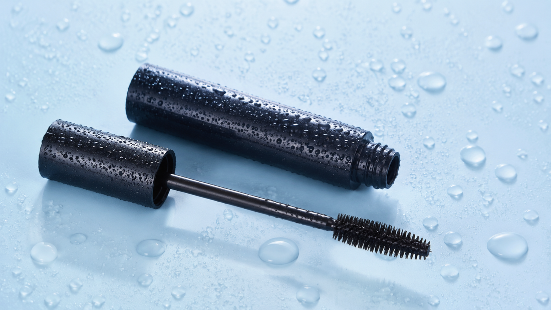 Unbranded waterproof mascara beside water droplets