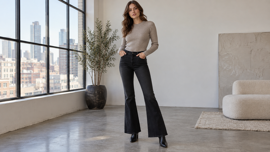 Adult woman wearing black flare jeans in a minimal city studio