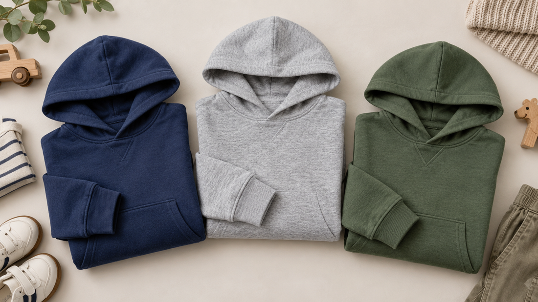 Boys hoodies in navy gray and green arranged in a neutral flat lay