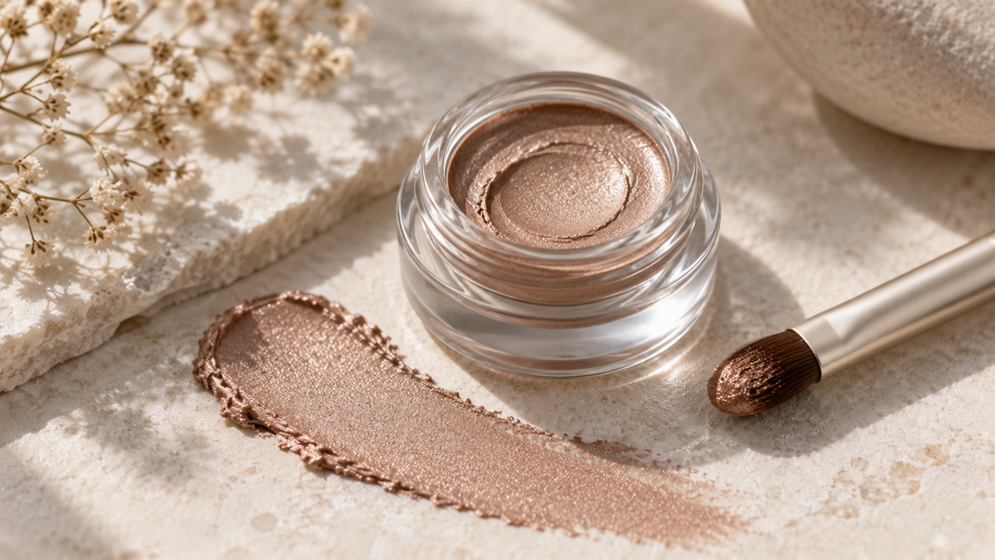 Editorial macro view of neutral cream eyeshadow and a clean applicator