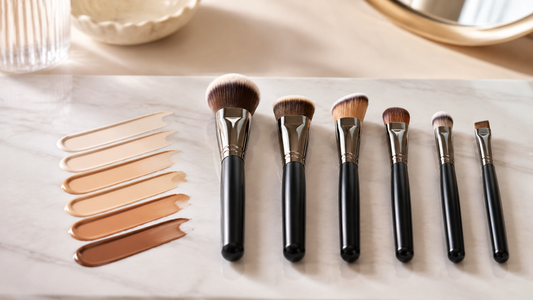Foundation brushes arranged beside subtle complexion swatches