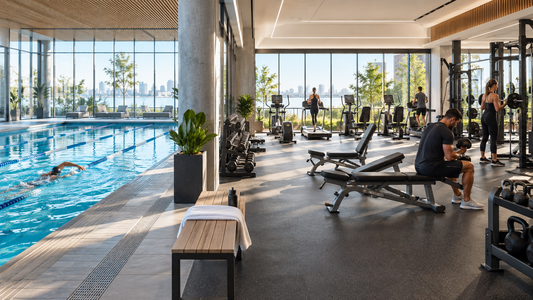 Modern fitness club with an indoor lap pool beside strength and cardio equipment