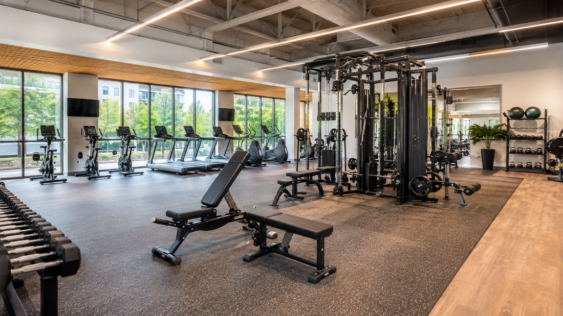 Bright neighborhood gym with strength equipment, cardio machines and an organized mobility area