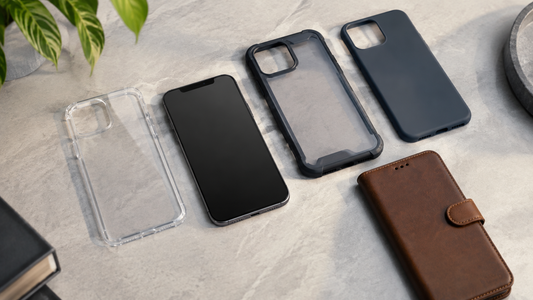 Unbranded clear, silicone, rugged and wallet phone cases arranged beside a blank-screen phone